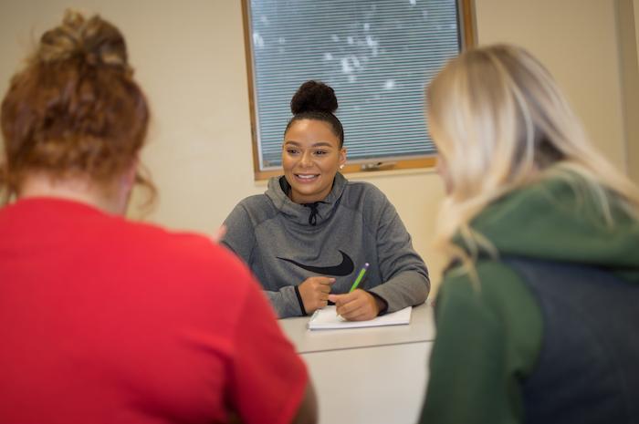 A communications major interviewing two other students